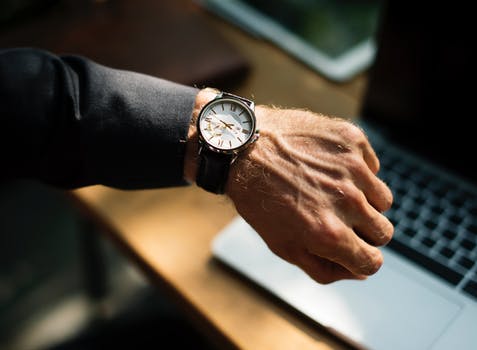 Man checking watch at his desk